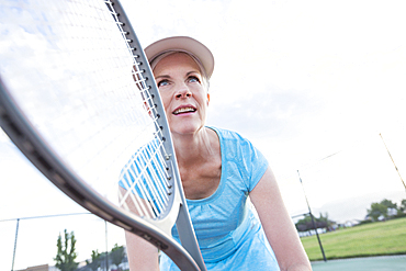 Caucasian woman holding tennis racket