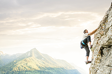 Caucasian man rock climbing