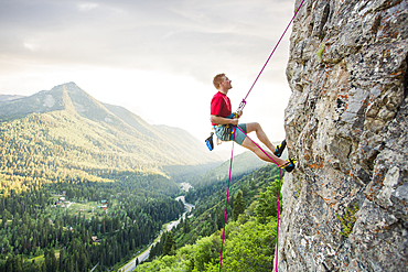 Caucasian man rock climbing