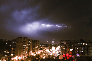 Lightning striking city at night