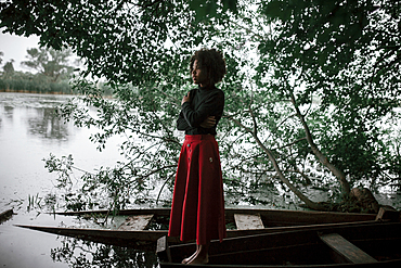 Caucasian woman standing in boat at river