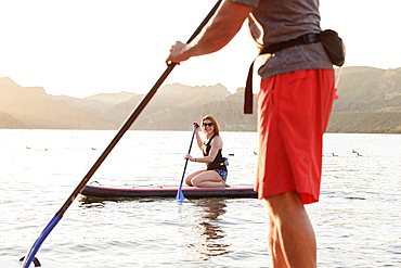 Couple on paddleboards in river