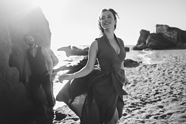 Caucasian couple walking on beach