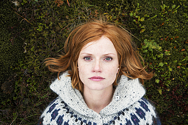 Portrait of Caucasian woman laying on moss