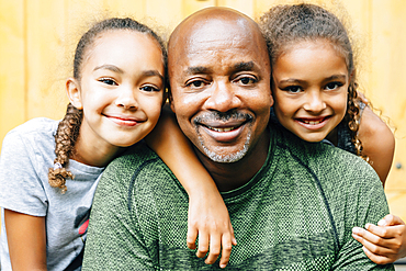 Portrait of smiling father and daughters