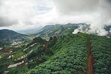 Clouds over mountain and green valley