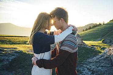 Caucasian couple rubbing noses and hugging