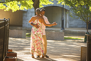 Black couple dancing in park