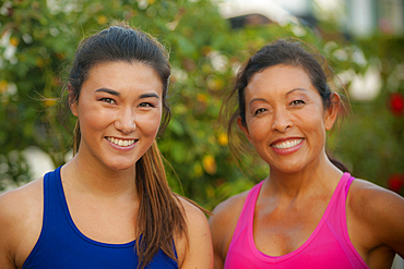 Portrait of smiling Mixed Race mother and daughter