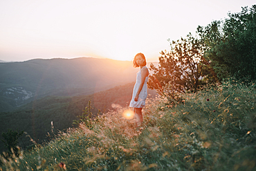 Serious Caucasian woman standing on mountain