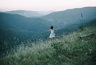 Carefree Caucasian woman walking on mountain