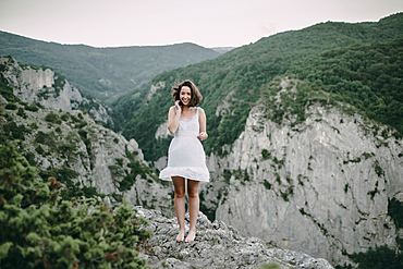 Smiling Caucasian woman standing on mountain