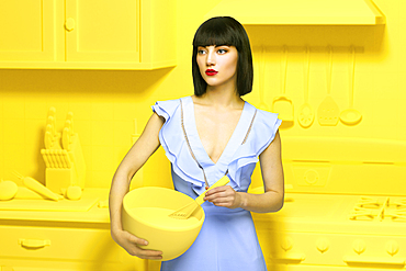 Caucasian woman in yellow old-fashioned kitchen holding mixing bowl