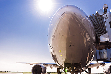 Low angle view of airplane at airport under blue sky