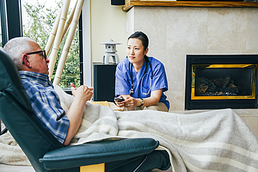 Nurse texting on cell phone near patient