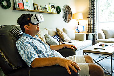 Caucasian man wearing virtual reality goggles