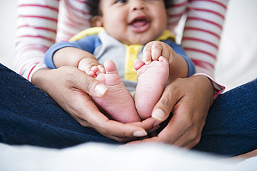 Mother holding baby son in lap