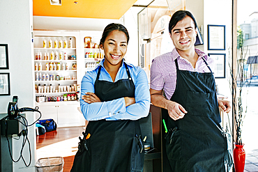 Smiling hairdressers posing in hair salon