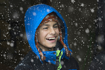 Mixed Race boy laughing in snow