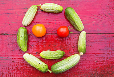 Cucumbers and tomatoes arranged in smiley face