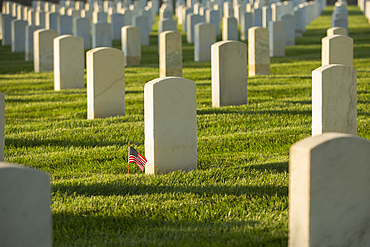 American flag at cemetery gravestone