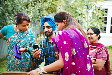 Family using cell phone in backyard