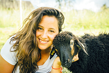 Caucasian woman posing with sheep