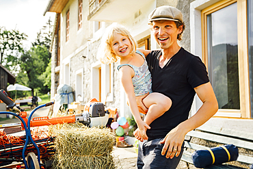 Caucasian man carrying daughter