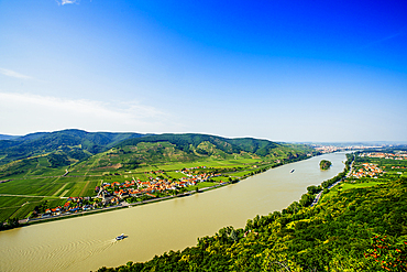 Boats on river near village