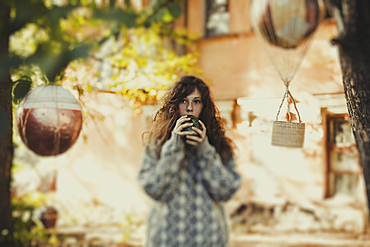 Caucasian woman holding ball near face