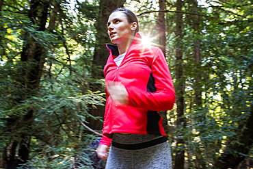 Woman running in forest