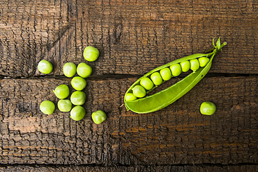 Fresh peas on wooden table