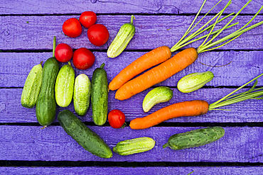 Fresh vegetables on purple wooden table