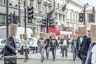 Anonymous people wearing paper bags on head in city