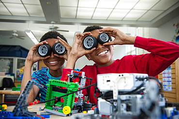 Boys playing with toy wheels in library