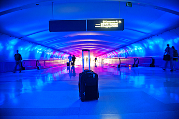 Abandoned suitcase in blue airport terminal