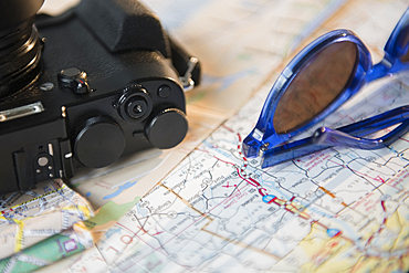 Camera, sunglasses and maps