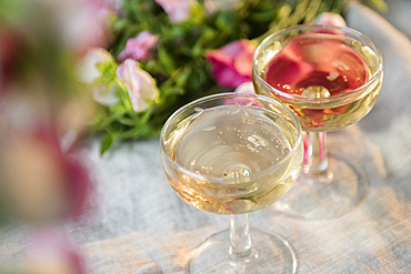 Glasses of champagne near flowers