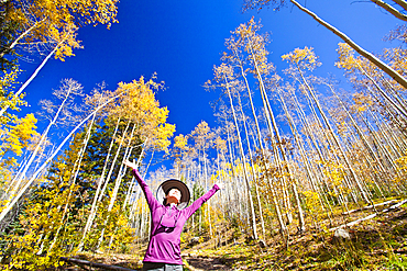 Japanese woman celebrating in forest