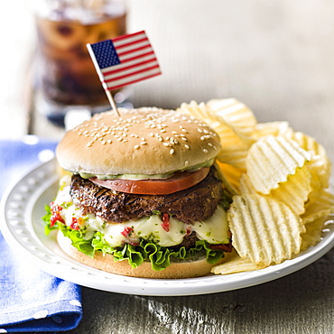 Cheeseburger and potato chips with American flag