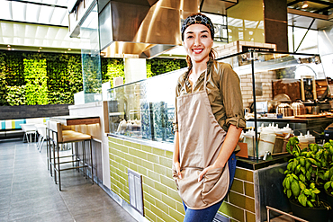 Portrait of smiling Mixed Race worker in food court