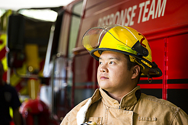 Chinese fireman standing near fire truck