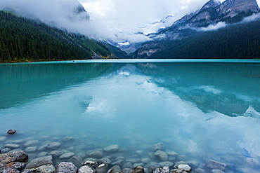 Reflection of clouds in still mountain lake