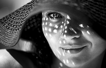 Smiling Caucasian woman wearing sun hat