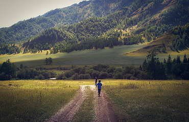 Caucasian boys walking on remote path