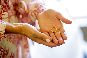 Caucasian woman holding wedding ring