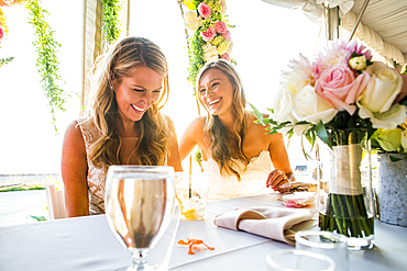 Caucasian brides sitting at table