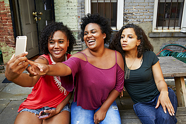 Smiling woman posing for cell phone selfie