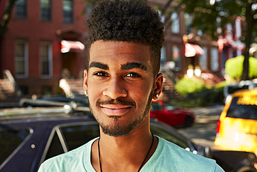 Portrait of smiling Black man in city