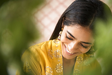 Smiling Indian woman looking down